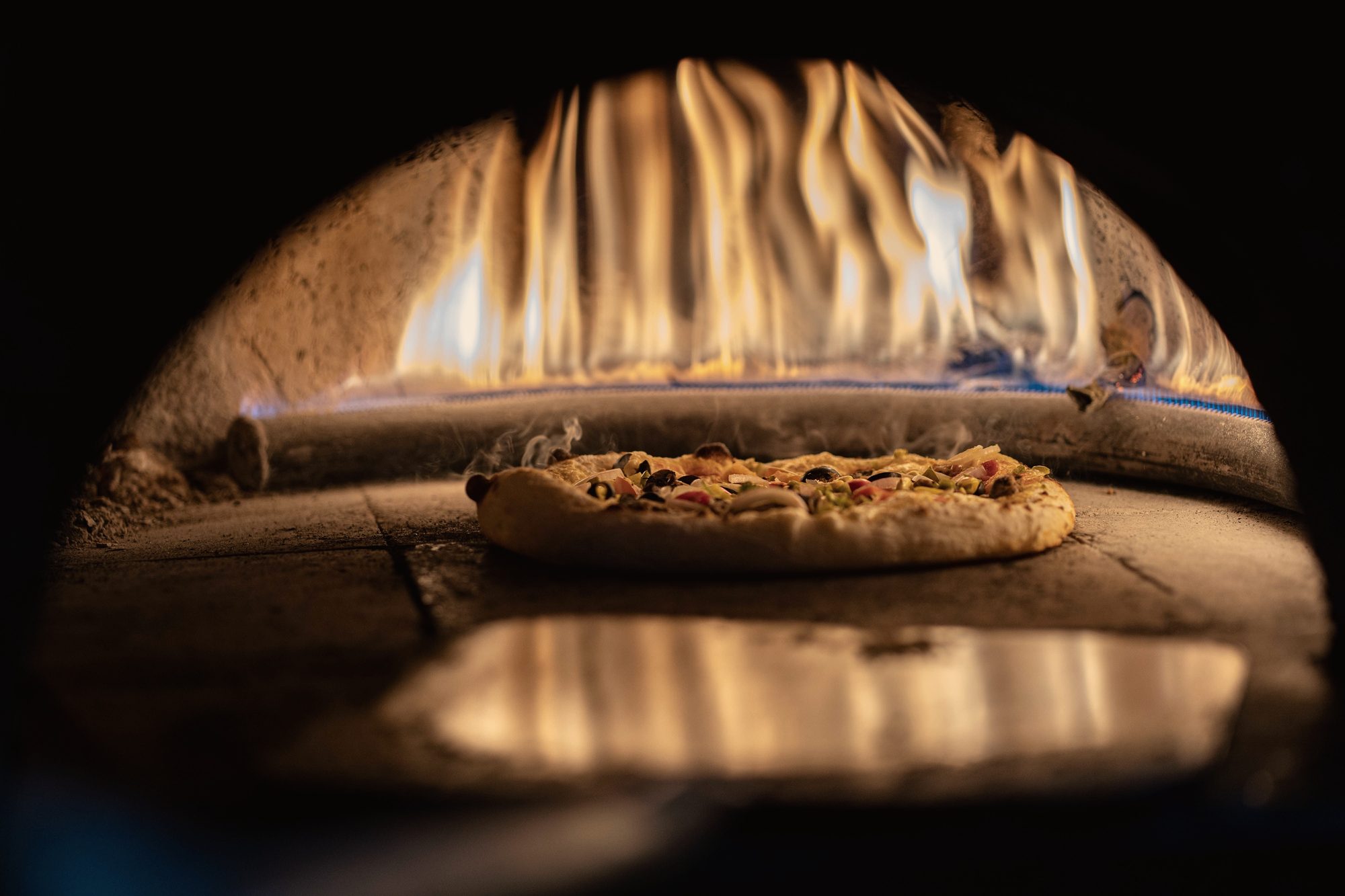 A pie on the oven floor under the flame-licked dome of the beast, the oak fire roaring across the ceiling